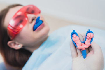doctor orthodontist performs a procedure for cleaning teeth - obrazy, fototapety, plakaty