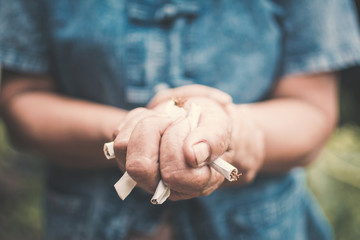 Old hand crushing cigarettes, Stop smoking concept.