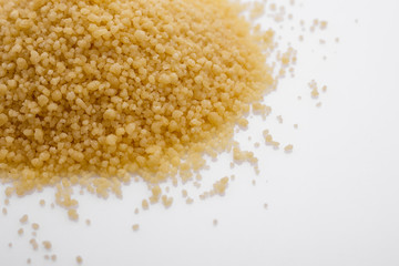 fresh couscous on a white acrylic background