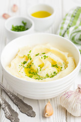 Mashed potatoes with parsley and olive oil in a bowl
