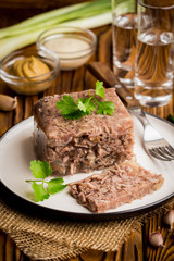 Jelly with meat, beef aspic, traditional Russian dish, portion on plate, mustard and horseradish