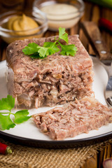 Jelly with meat, beef aspic, traditional Russian dish, portion on plate, mustard and horseradish