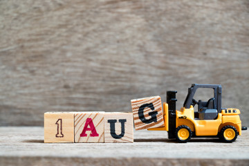 Toy forklift hold block G to complete word 1 aug on wood background (Concept for calendar date in month August) - obrazy, fototapety, plakaty
