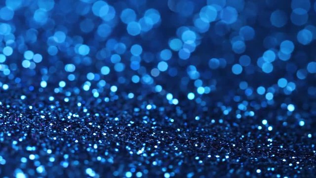 Blue glitter texture rotating. Abstract shiny background.