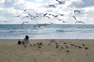 The sea, with waves on the background of blue sky and clouds