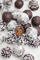 Vegan sweets made from prunes, dates, almonds, sesame, nuts, hazelnuts, nuts, chocolate, goji berries