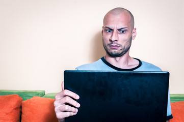 Funny reaction and facial expression of the man who find out online inappropriate content in the...