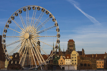 Ferris wheel on the background of the beautiful city of Gdansk. Poland