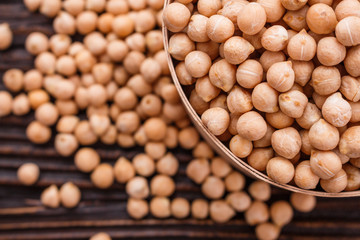 uncooked chickpeas on a wooden rustic background
