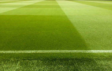 an empty football stadium with green grass