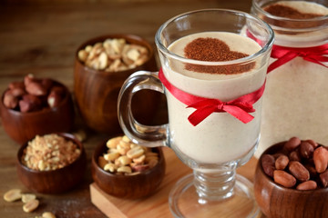 Milkshake decorated with cinnamon heart in glass vessels