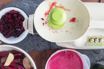 Making beetroot and apple juice with slow juicer. 