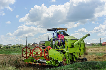 The farmer on the combine harveste.