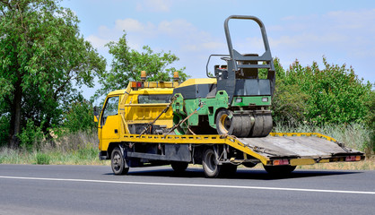 Ukraine, Odessa. June 15, 2018. The route Odessa - Nikolaev. Tow truck and asphalt roller on the...