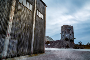 Old wooden and concrete building at a sand mining area