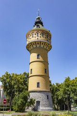 Obraz premium The Wilhelminian water tower, 1906, height 50 m, on the left a blooming horse chestnut