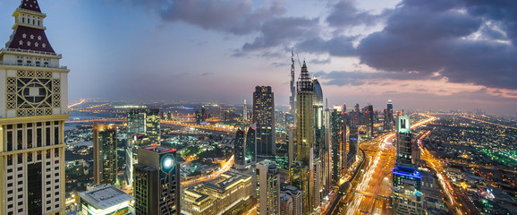 Aerial panoramic view of a big futuristic city by night.