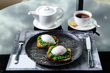 toasted bread with poached egg and Greens