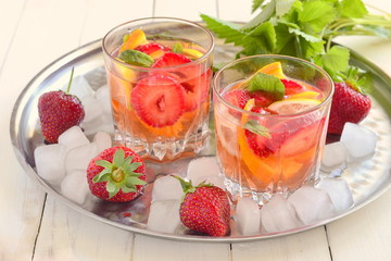 Refreshing summer drink with strawberries and  citrus
