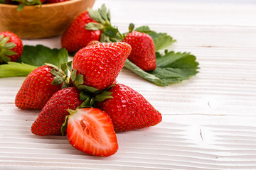 Juicy fresh strawberry on a rustic wooden background