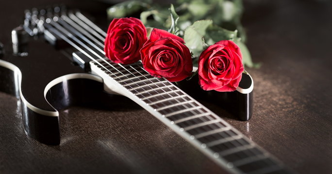 three roses on black guitar