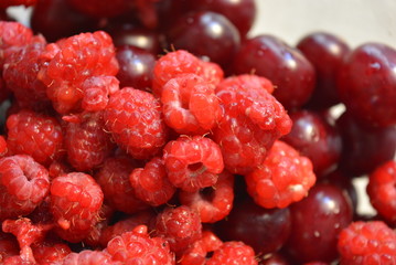 Fresh fruits of cherries and raspberries in glass