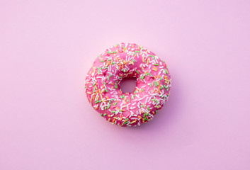 Fresh sweet donut on pink background. Abive view