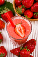 fresh strawberrysmoothie or milkshake on a wooden rustic background