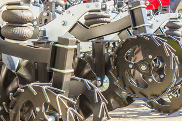 Mechanisms for the tractor are used for cultivating the land and planting seeds. Mechanization of agriculture.