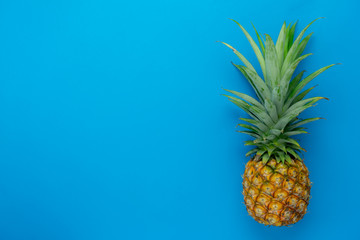 Table top view aerial image of food for  summer holiday season background.Flat lay object the fresh pineapple on modern rustic blue paper wallpaper.Free space for creative design add text and content