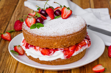 Victoria Sponge Cake with whipped cream and strawberry