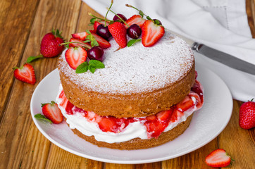 Victoria Sponge Cake with whipped cream and strawberry