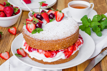 Victoria Sponge Cake with whipped cream and strawberry