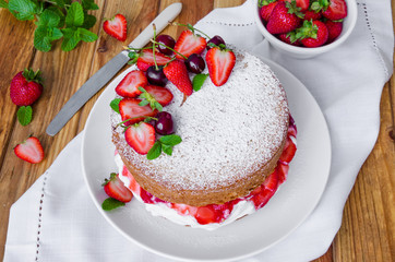 Victoria Sponge Cake with whipped cream and strawberry