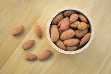 Almond seeds in wooden bowl.