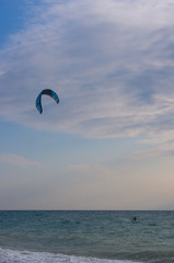 kitesurfer rides a kite-surf on waves of the sea