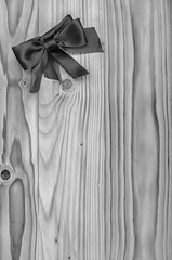 Black mourning ribbon on a wooden table.