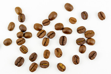 close up of medium or dark roasted coffee beans isolated on white background, can be used as a background or graphic object in your ads.