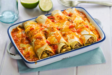 Beef enchiladas with tomato sauce and cheese - 210562407