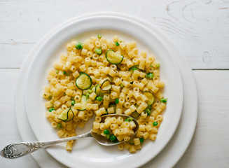Healthy homemade organic vegetarian pasta with zucchini and pea top view