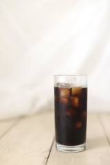 Iced coffee black coffee isolated on wooden table
