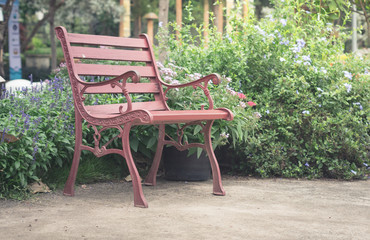Fototapeta na wymiar Metal brown bench in garden,vintage filtered.