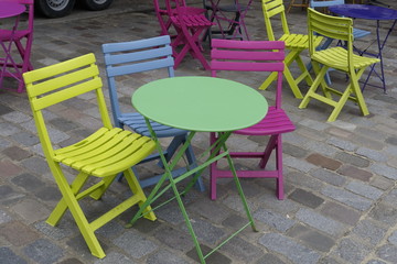 Tables et chaises colorées. Petite terrasse de café.