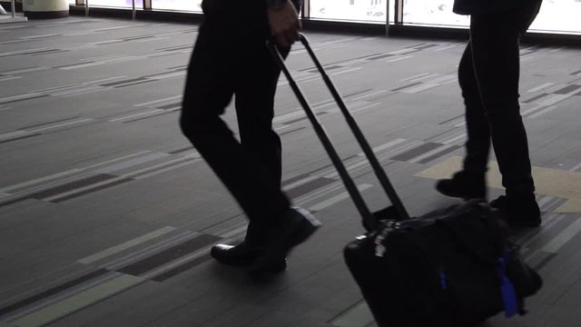 Businessman with luggage walking in the airport, Business trip concept (Slow motion)