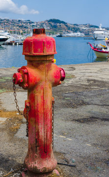 Ancient fire pump of water in the port of Sanremo.