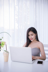 Smart girl's working on notebook , Workingwoman using laptop in the room