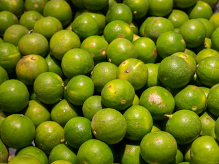 Natural skin fresh green lemons in market