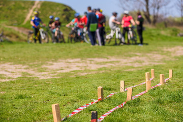 Cycling obstacle course, group of bike riders on the background