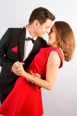 Portrait of beautiful young man and woman dressed in classic clothes in love