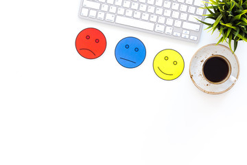 Customer satisfaction concept. Emoji smile, neutral, sad on work desk on white background top view copy space